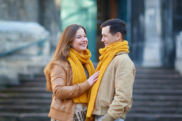 Couple of tourists taking a walk in a city street sidewalk in a sunny day