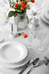 Served table with flowers in restaurant, closeup