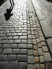 Obraz premium Paved Road With A Human Shadow