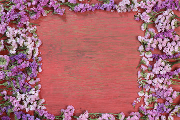 Red flowers on a wooden floor.