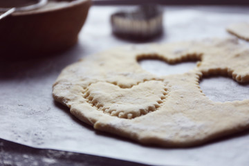 Uncooked heart shaped biscuits on a table