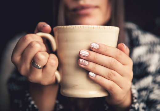 a cup of coffee in a beautiful female hands and beautiful lips