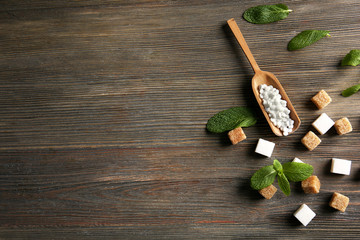 Sugar cubes and stevia  on wooden background - obrazy, fototapety, plakaty
