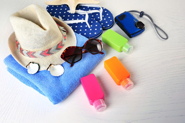 Summer accessories on wooden table, close up