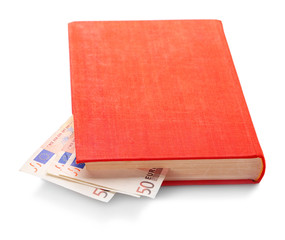 Red book with nested euro banknotes, isolated on white. Stash of money