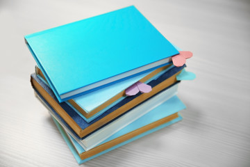 Heart bookmarks for books on wooden table closeup