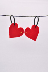 Red felt hearts pinned together on a line