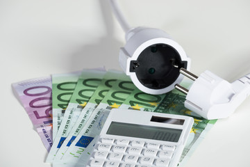 Fototapeta premium Calculator With Electric Plug With Euro Banknotes