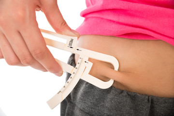 Woman Measuring Fats With Caliper