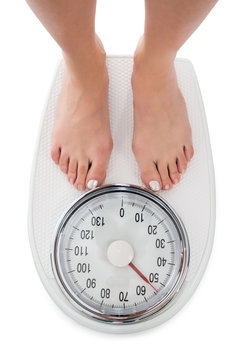 Directly Above Shot Of Woman Standing On Weight Scale