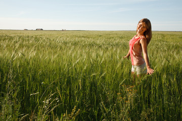 Naklejka na ściany i meble Cheerful Girl stands on the summer field