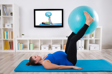 Pregnant Female Exercising With Fitness Ball