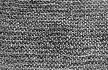 gray background of knitted woolen braids knitting stitch