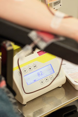 Donor in an armchair donates blood,, close-up