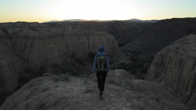 Young girl walking through the Canyons at sunset