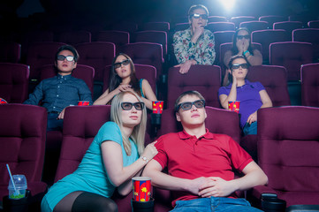 People in the cinema wearing 3d glasses