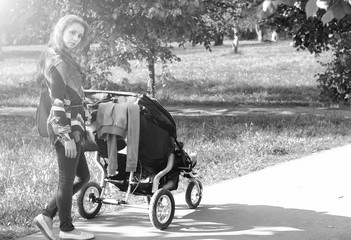 Fototapeta na wymiar walk women with stroller summer sunlight
