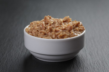canned tuna in white bowl on slate