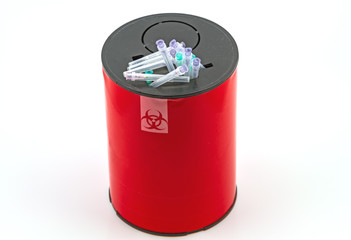 Many  needle in red disposal boxes on white background