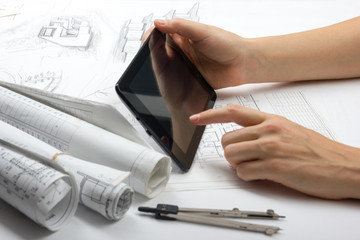 Architect working on blueprint. Architects workplace - architectural project, blueprints, ruler,...