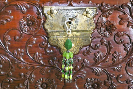 Closeup of an old keyhole with key on a wooden antique background
