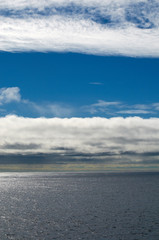 Seascape with blue sky and white clouds