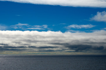 Seascape with blue sky and white clouds