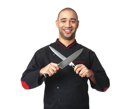 Afro American professional cook holding knifes - isolated.