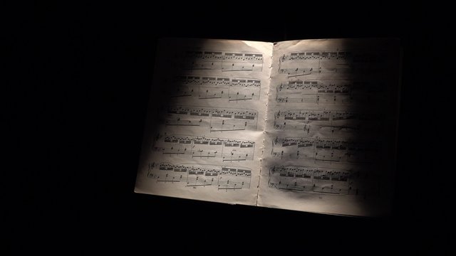 Vintage music notes with ray of light on black