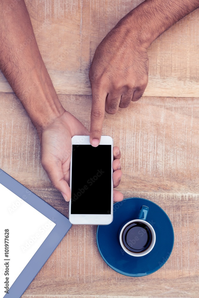 Poster cropped image of man using smart phone by coffee