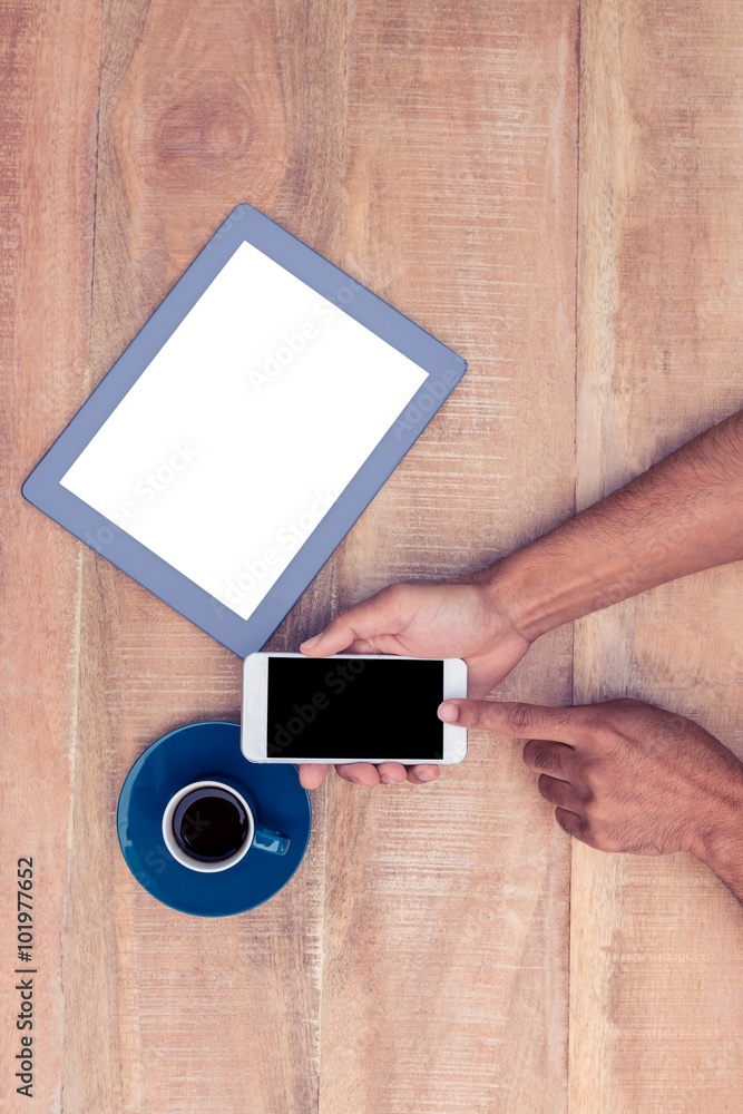 Poster Man using smart phone by coffee and tablet on table