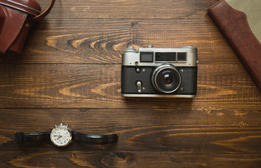 Set of vintage photojournalist accessories on wooden background