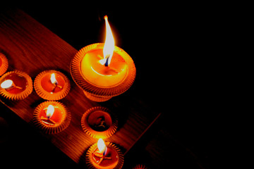 The candle with black background space on the right side for text, selective focus on the biggest candle

