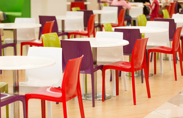 Colorful plastic chairs and tables in canteen