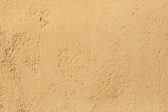 Yellow stucco wall. Background texture