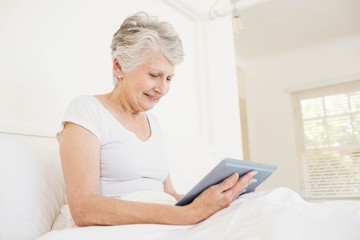 Smiling woman using tablet