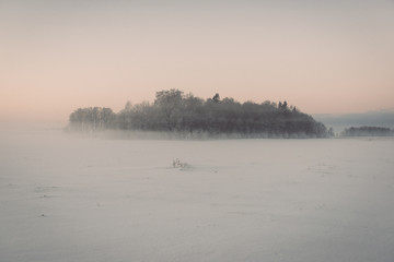 foggy country fields in winter on cold morning - vintage effect