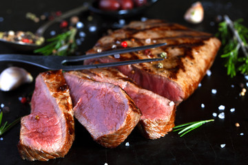 Grilled beef steak with spices, garlic and rosemary