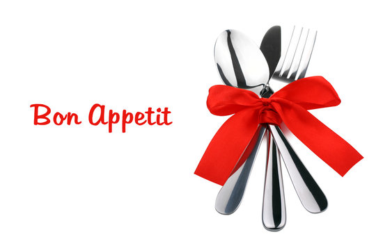Silver fork and spoon, knife tied with a red ribbon isolated on white background