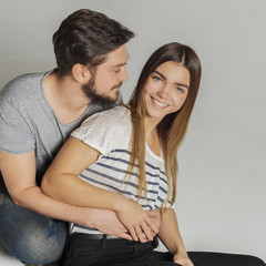 Casual loving couple on grey background