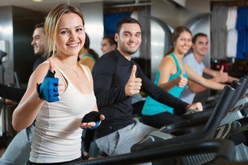 Fototapeta na wymiar Group positive working out of cycling in fitness club