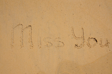 MISS YOU message on the beach