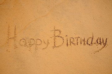 happy birthday sign on the beach
