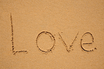 love word written on brown sand