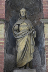 Fototapeta na wymiar Historic Jesus on the mystery winter old Prague Cemetery, Czech Republic