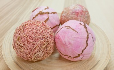 Fototapeta premium Four Decorative Paper Balls on Wooden Tray