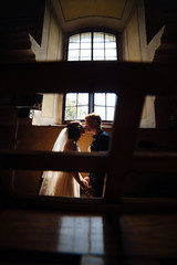 bride and groom on the background of a window.