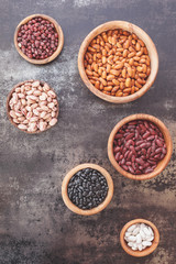 Dried  beans.  Still life of  various types of dried beans in  a wooden bowls.