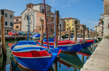 Fototapeta na wymiar Fisherman boats moored along channel in Chioggia