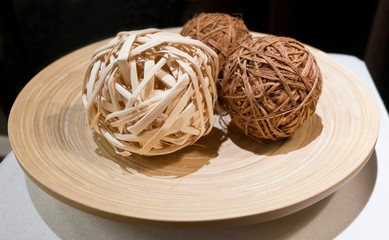 Woven Wickers or Bamboo Balls on Wooden Tray